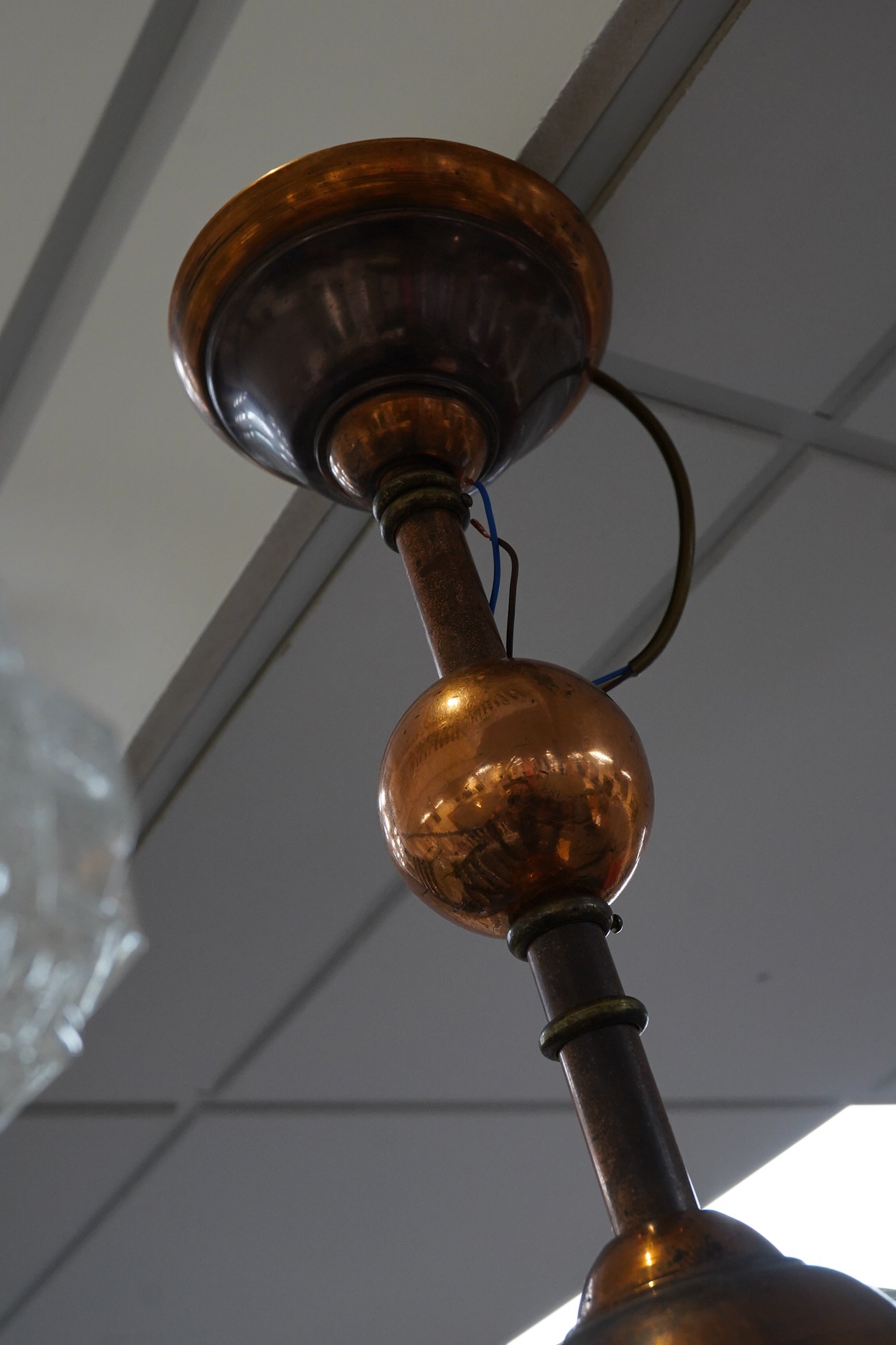 A French Art Deco brass oxidised copper plated five arm chandelier with original shades, circa 1920’s-1930’s, wired, overall 56cm high, 72cm. Condition - fair to good, not tested
